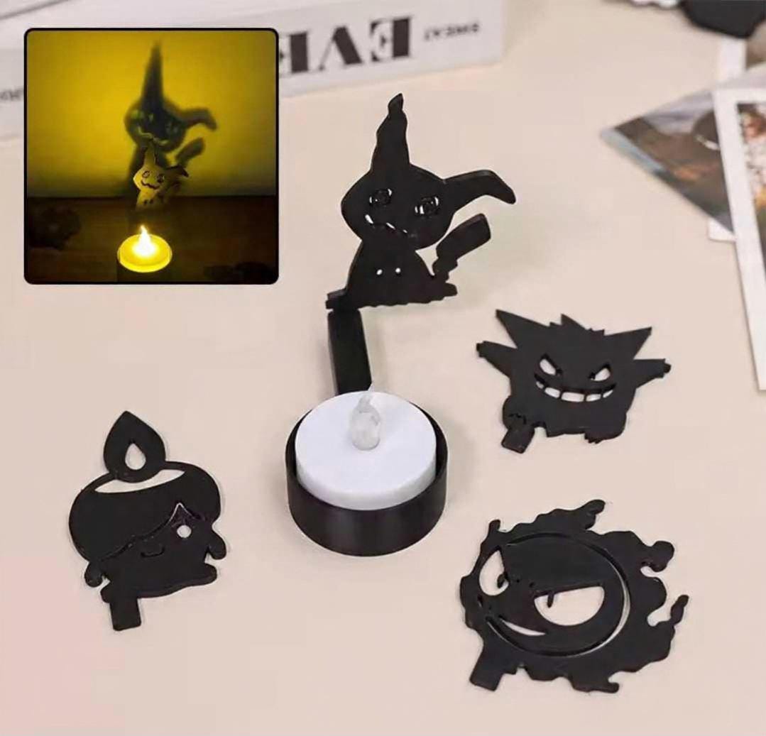 Gengar and Mimikyu shadow projection on wall from spectral pillar lamps.