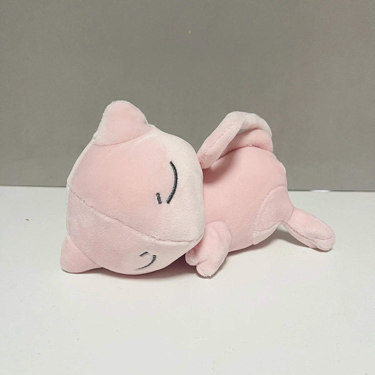 Premium Mew 19cm artisan plush with long tail and pink high-density fiber.