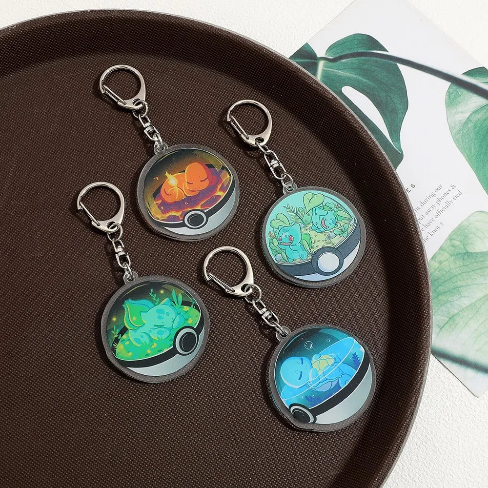 Handheld view of Pokemon starter keychains showing scale and clarity.