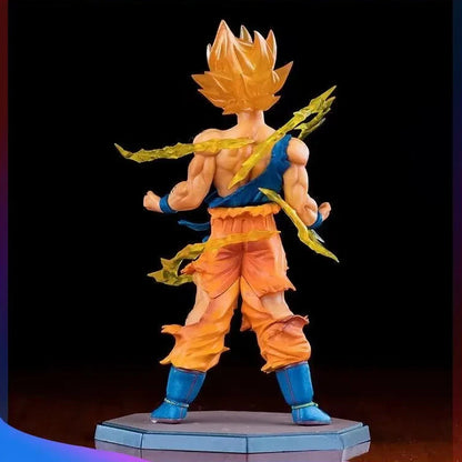 Action figure of a character in orange and blue outfit with flames on head and shoulders, holding two golden weapons on a black background.