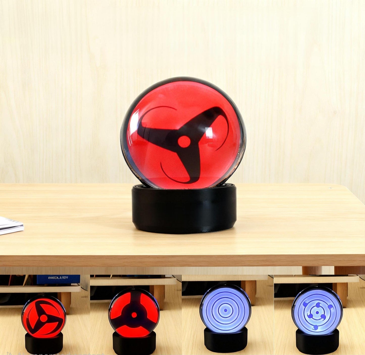 Infinite Sharingan LCD sphere showing the classic three-tomoe ocular pattern.