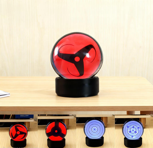 Infinite Sharingan LCD sphere showing the classic three-tomoe ocular pattern.