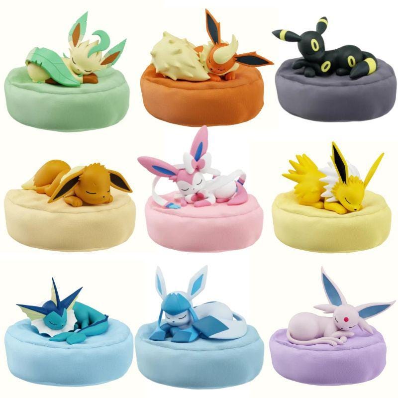 Complete 9-piece set of sleeping Eevee evolution figures including Eevee, Vaporeon, Jolteon, Flareon, Espeon, Umbreon, Leafeon, Glaceon, and Sylveon.