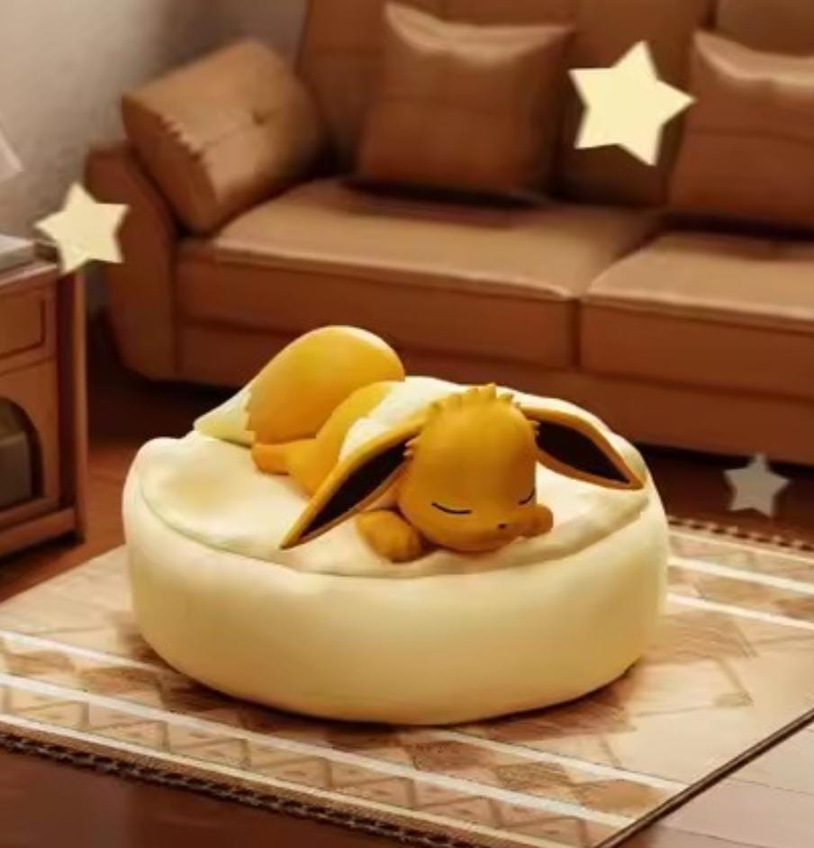 Classic Eevee figure sleeping on a cream-colored soft-touch cushion, high-quality PVC Pokémon ornament from the 9-piece Dreamy Evolution set.