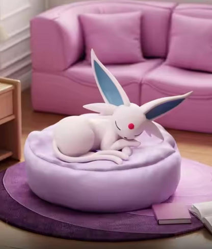 Espeon, the sun Pokémon, sleeping on a lavender-purple bed, showing signature forehead gem and tail details, Aura Domain Core exclusive figurine.