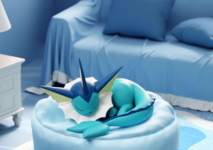 Detailed sleeping Vaporeon figure featuring translucent fins and tail on a light blue cushion, high-quality anime figurine for desk display.